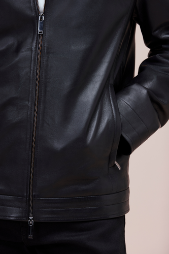 Lamb leather bomber with slim fit, zip features, and quilted lining for versatile style.