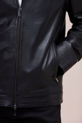 Lamb leather bomber with slim fit, zip features, and quilted lining for versatile style.